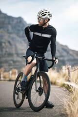 Obraz premium Person, cyclist and bicycle with back pain outdoor for bad posture, discomfort or strain. Fitness, accident or biker with sore muscle, injury or joint inflammation for workout on mountain road