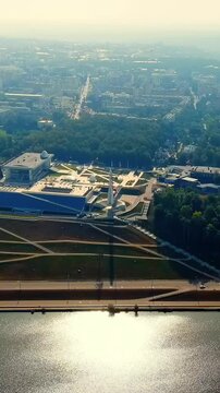 Vertical video. Kaluga, Russia. Tsiolkovsky State Museum of the History of Cosmonautics, its angular concrete and glass facade and towering Vostok rocket monument. Drone footage, Point of interest. R