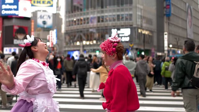 Two Women in Harajuku Fashion Dancing at Shibuya Crossing Tokyo