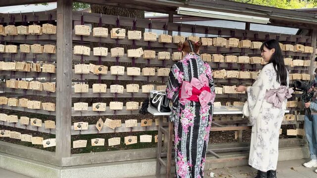 Japanese Women in Kimonos Hanging Ema Prayer Plaques at Meiji Jingu Shrine