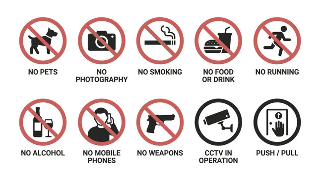 A collection of warning signs prohibiting various activities in a public area.