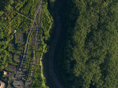 Aerial view of Bunker Kaliadem Merapi area featuring a deep volcanic ravine and dense tropical forest in Kecamatan Pakem, Daerah Istimewa Yogya, Indonesia.