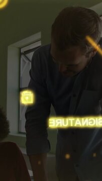 Vertical video: Tutor leaning over student placing hand guiding causing education holo SIG or BEH or