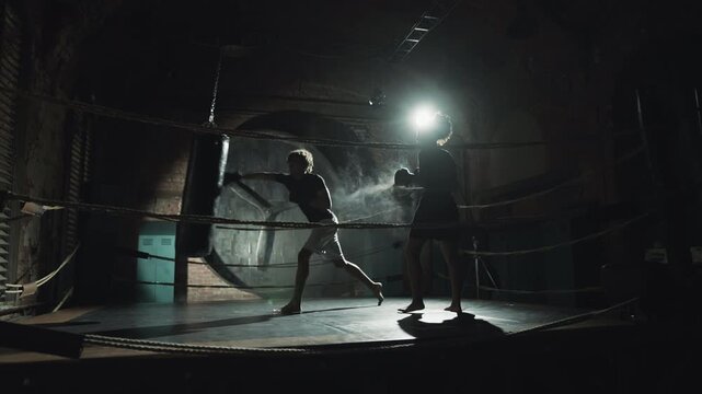 Active motivated woman training in boxing ring, coach demonstrating punches. Self-defense class for ladies, professional sport and active hobby for stay healthy, slender, beautiful, fitness club