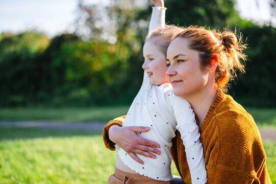Mother and daughter looking into distance, copy space