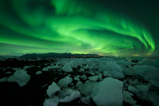 Aurora borealis over snowy mountains