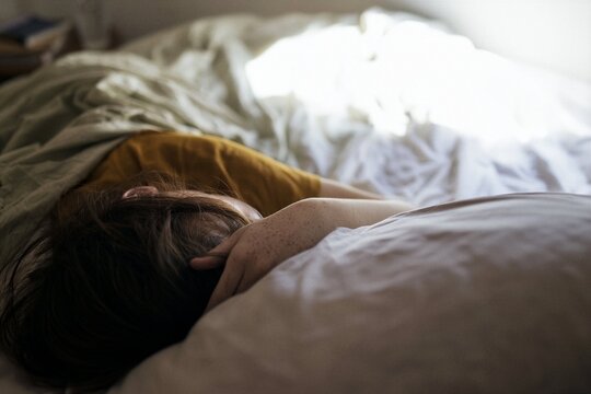 Young woman resting in bed during quiet morning