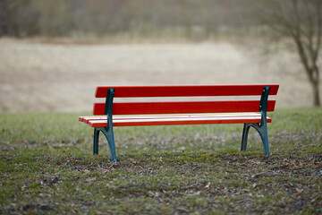 Naklejka premium Park, bench and river with nature, outdoor and scenery for peace and quiet or environment. Public, lake and empty seat for season, solitude and natural garden with landscape, trees and greenery