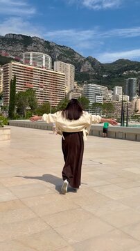A girl walks along the promenade in Monaco, Monte Carlo