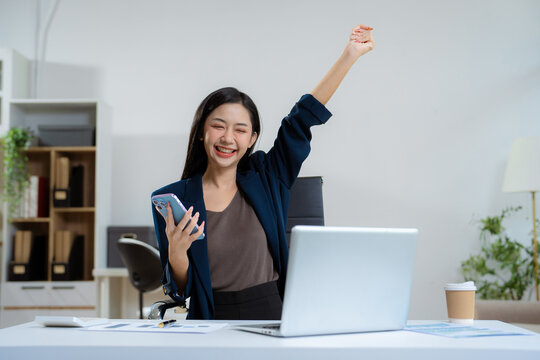 Overjoyed charming excited woman business woman worker using smartphone.