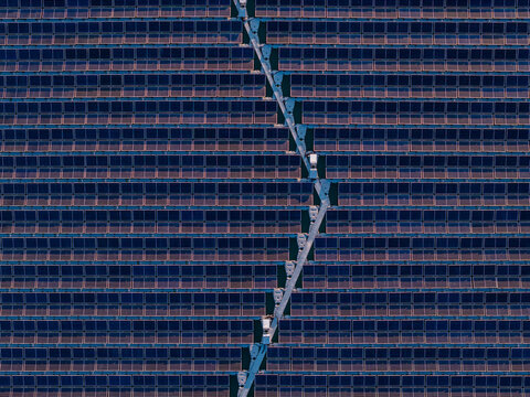 Aerial view of floating solar farm with rows of panels and a central walkway on the water in Bensheim, Hessen, Germany.