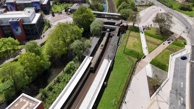 Aerial birds eye view of University train station and departing train, Edgbaston, Birmingham