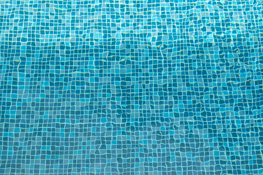 Swimming pool water surface and ripple wave with blue mosaic tiles