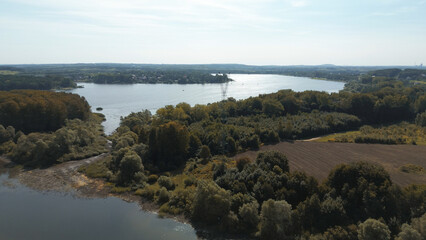 Obraz premium High voltage power lines over scenic lake
