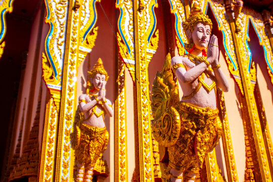 Exquisite Golden Kinnara Statues Guarding Traditional Thai Temple