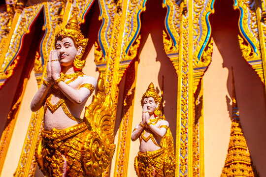 Exquisite Golden Kinnara Statues Guarding Traditional Thai Temple
