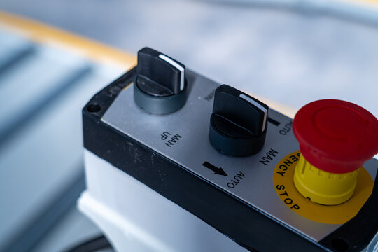 Industrial control unit with selector switches and red emergency stop button