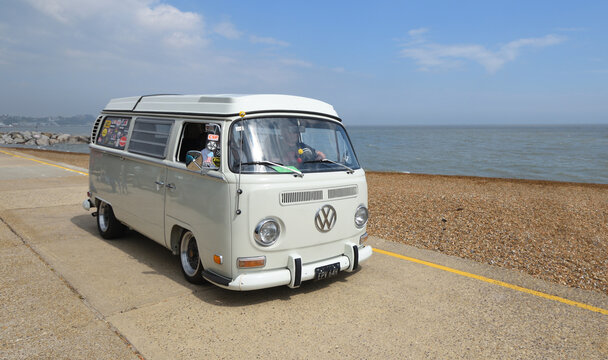 Felixstowe, Suffolk, England - May 03, 2026: Classic white Volkswagen Type 2 camper van on seafront promenade beach and sea in background.