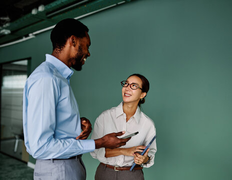 Portrait of young businesswoman and businessman using a tablet having a meeting or presentation and seminar in the office