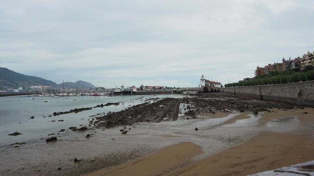 Flysch rock formations revealed during low tide at getxo harbor