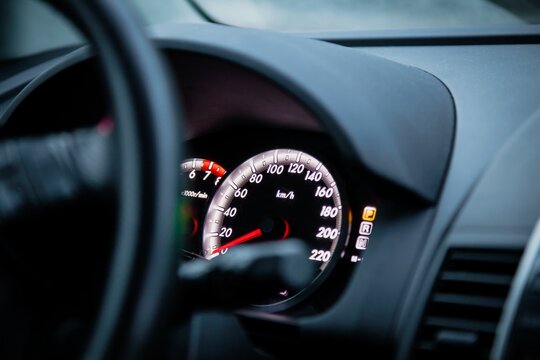 Detailed Close-Up of Car Dashboard with Speedometer and Odometer Displaying Metrics in Clear...