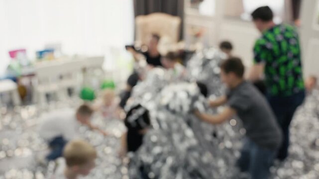 Children playing joyfully. Vivid scene of kids climbing. Energetic children exploring shimmering ball pit