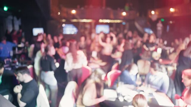 Nightlife energy captured. Vibrant club scene in motion. Lively dance floor with drinks and flashing lights
