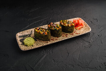 Gunkan maki sushi with eel and ginger on dark stone © AntAlexStudio