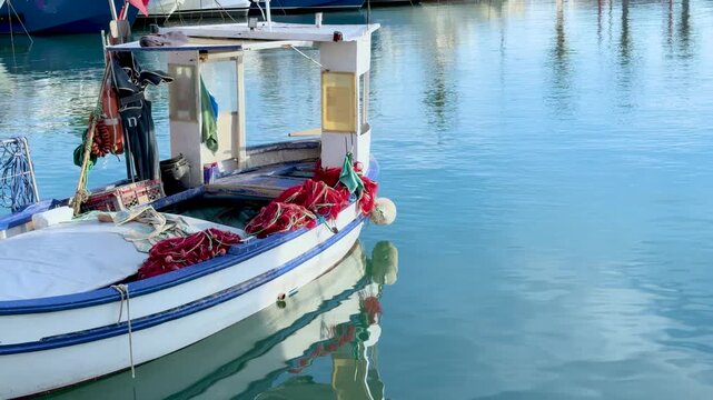 Traditional Fishing Boat with Red Nets Docked in Cassis Harbor