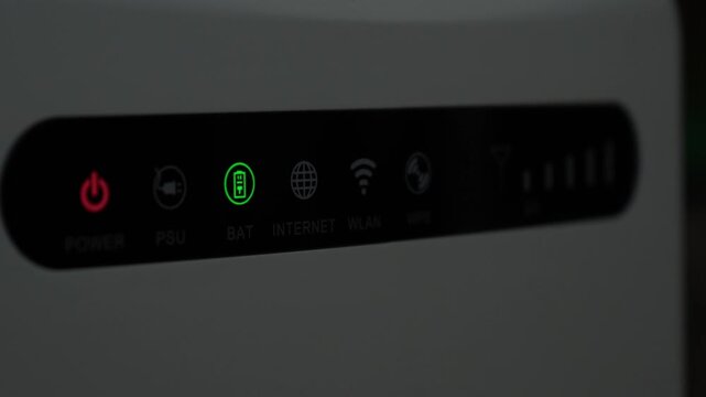 Close up of router LED indicators with blinking network signal. Shows internet activity and connection status in real time.