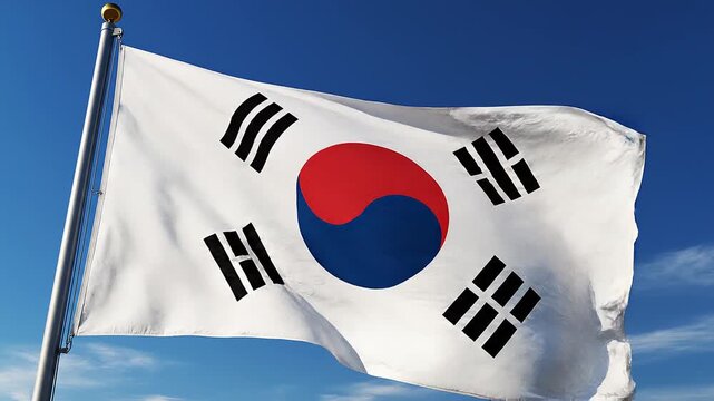 The Taegeukgi flag waves under a clear sky, symbolizing harmony, balance, and national identity with yin‑yang and trigrams representing universal principles of existence.