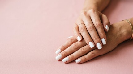 Fototapeta premium Woman’s hands with white manicure on pink background, clean commercial composition for Adobe Stock, useful marketing visual, neutral unbranded setting, copy space, authentic details, balanced layout,