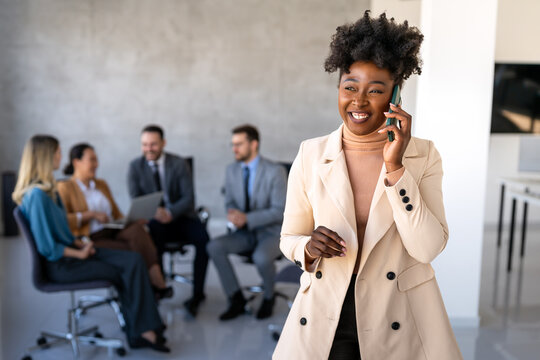 Smiling successful business woman, freelancer, coworker female leader using digital device, phone