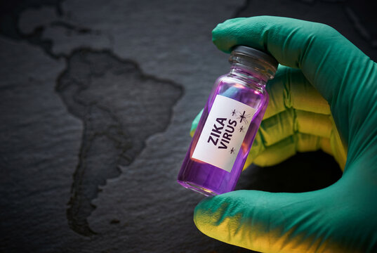 Laboratory hand holding zika virus vial over south america map
