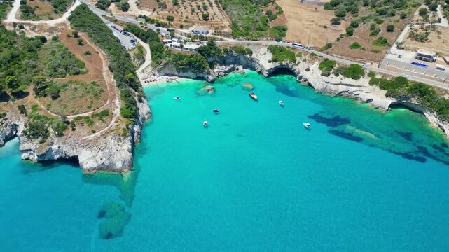 Spectacular drone view of Xigia Sulfur Beach in Zakynthos. Famous for its healing sulfur springs, crystal turquoise water, and steep limestone cliffs in a scenic Greek island bay.