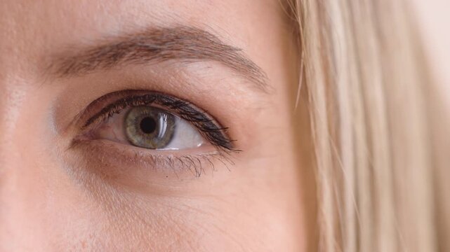 Woman, eye and optometry with blink for sight assessment, test or optic nerve reflex. Closeup, female person or optometrist with eyesight, iris or retina for vision improvement, exam or awareness