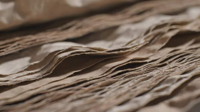 Close up view of stacked craft paper sheets with textured edges and subtle shadows creating a tactile aesthetic