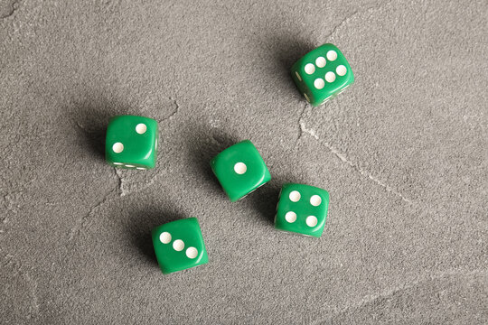 Green dices on grey background