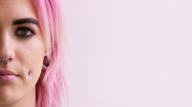 Space, happy and face of woman in studio with confidence for piercing, salon promotion and jewelry. Mockup, smile and half portrait of person with accessories for advertising on pink background