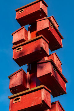 Stockholm, Sweden Large red wooden birdhouses in a park.