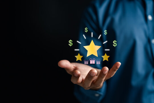 Loyalty points and customer rewards program solution. Man holding digital graphic with gold star, dollar sign and gift box for business promotion.