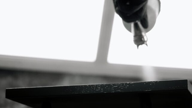 Close up of automated CNC woodworking machine processing furniture panel in factory. Industrial furniture manufacturing and precision woodworking concept.