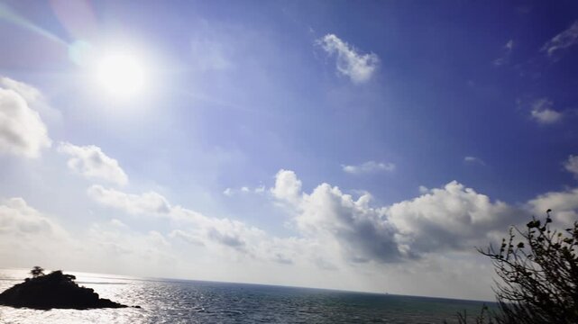 The location shows Cong vien Nginh Phong with a view of the ocean and clouds. People can be seen enjoying the surroundings. The sky appears with blue and white colors.
