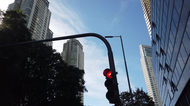 Low Angle Panning Puerto Madero Skyline with Red Traffic Light and High Rise Buildings