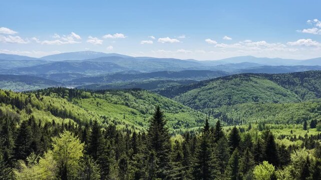 Leskowiec a peak in the part of the Little Beskids. Aerial view of Leskowiec mountain shelter and green Beskid landscape day in Poland with green forests, rolling hills and sunny spring atmosphere