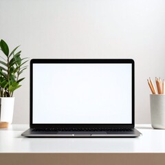 Fototapeta premium Modern workspace with a blank laptop screen mockup. This minimalist setup including a plant and pencils represents productivity, ideal for digital marketing and creative online presentations.