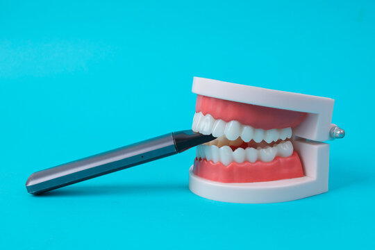 Electronic Cigarette Held In Human Jaw Model Dental Health Concept