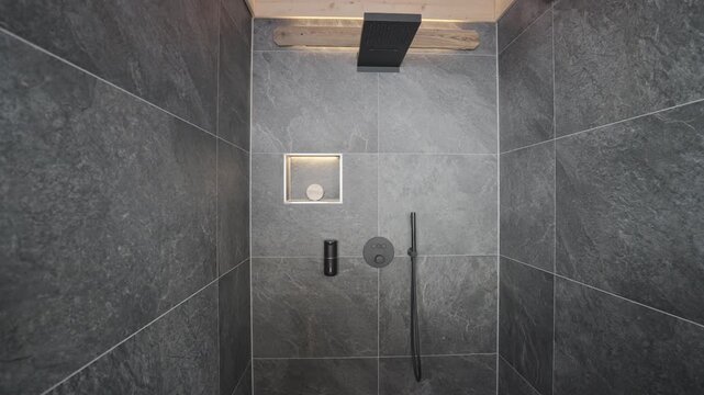 Elegant and contemporary bathroom interior with a walk in shower featuring dark grey slate tiles