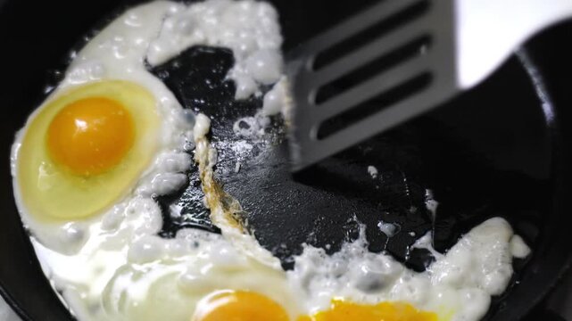 making fried eggs for breakfast