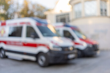 Blurred ambulance vans parked at emergency medical service station © Irina